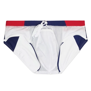 Detail of men's swim briefs featuring red white blue patchwork and adjustable drawstring
