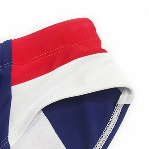 Detail of color-block swim briefs showing red white blue paneling and reinforced stitching