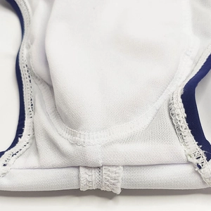 Close-up of breathable white mesh lining and navy blue seams on men's swimwear