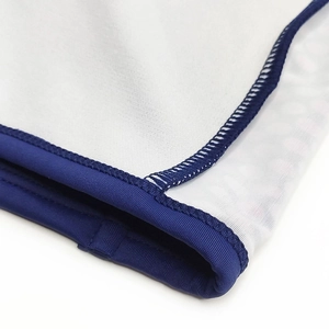 Gros plan d'un maillot de bain blanc avec bordure bleue et coutures extensibles