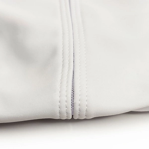 Detailed close-up of double-needle stitching on white elastic men's swim trunks