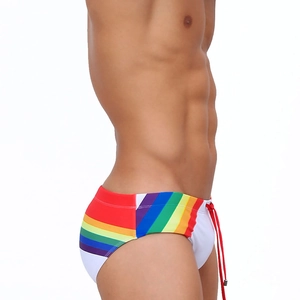 Detail view of rainbow striped men's swim briefs with adjustable red drawstring
