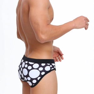 Détail du slip de bain homme noir à pois blancs avec une large ceinture élastique