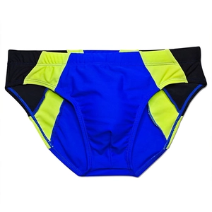Detail view of quick-dry athletic swim briefs with royal blue and yellow patchwork design