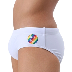Detail of white low-rise swim briefs with rainbow logo and Love is Love print on side