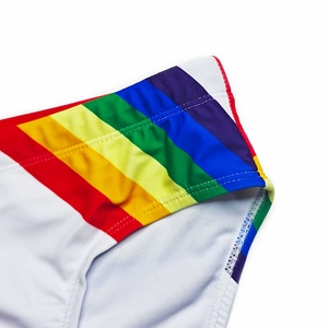 Macro shot of white swim trunks featuring rainbow side stripes and durable double stitching
