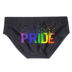 Close-up of rainbow gradient PRIDE lettering and bird print on men's quick-dry swim briefs