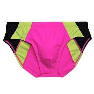 Flat lay of men's athletic swim briefs with neon pink and green color-block design