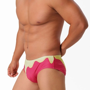 Detail of pink and yellow gradient men's swim briefs with fluid drip pattern design