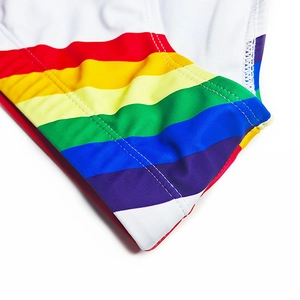 Detailed macro view of rainbow side stripes on white men's swimming trunks fabric