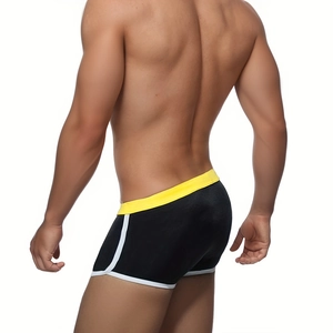 Rear view of tight men's swim trunks in black, yellow, and white color block design