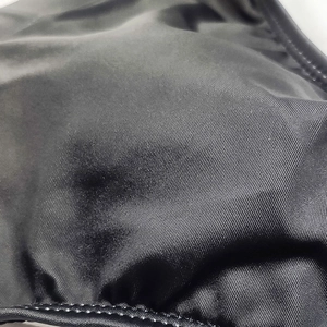 Detail of durable high-elastic synthetic fabric and reinforced stitching on men's swim briefs