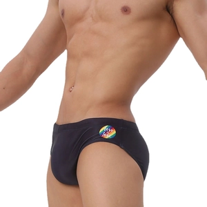 Men's low-rise black swim briefs with rainbow print and Love is love slogan on side