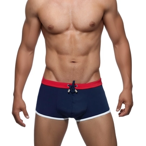 Men's navy blue swimming trunks with red contrast waistband and drawstring detail