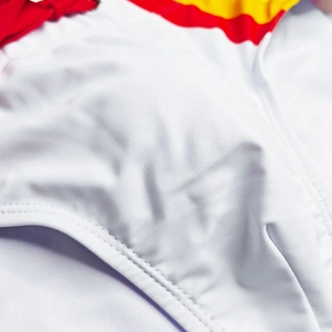 Close-up of white rainbow swim trunks featuring flatlock stitching and elastic fabric