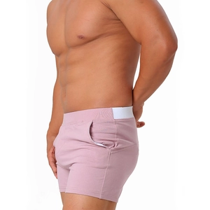 Side view of pink men's cotton lounge shorts with elastic waistband and functional pocket