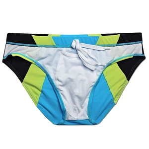 Close-up of color-block swim briefs with elastic waistband and white drawstring detail