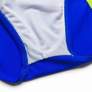 Detail of royal blue men's swim briefs featuring neon green side panels and breathable white lining
