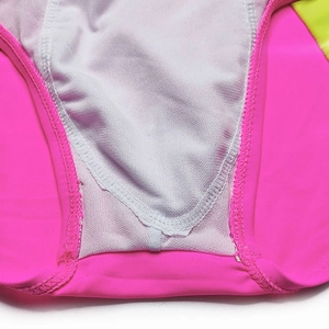 Macro detail of breathable mesh lining and flatlock stitching on contrast swim trunks