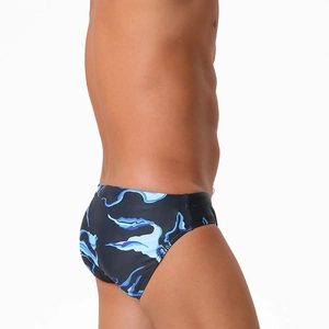 Detail of men's low-rise swim briefs with blue streamline print and quick-dry fabric