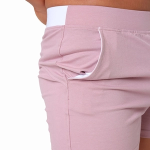 Detail of pink cotton lounge shorts featuring white elastic waistband and side pocket