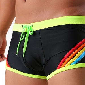 Detail of black swim trunks with neon yellow waist and rainbow stripes for men