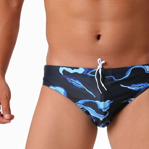 Detailed view of men's blue wave print swim briefs with drawstring waist and low-rise cut