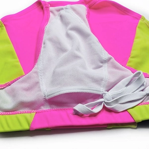 Detail view of neon pink and green swim briefs with breathable mesh lining and drawstring