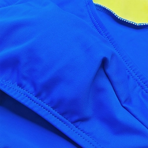 Detailed close-up showing reinforced double stitching on high-stretch blue swimwear fabric