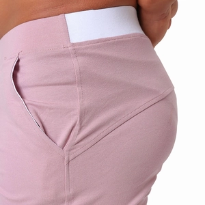 Macro detail of the elastic waistband and pocket stitching on men's cotton lounge shorts