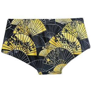 Detailed view of men's swim trunks featuring golden Japanese fan patterns and wide waistband