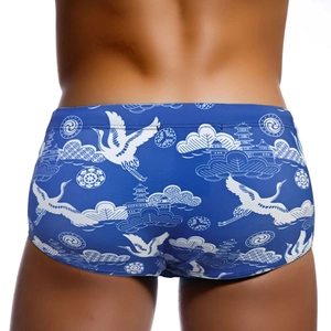 Blue men's swim trunks featuring white crane and auspicious cloud patterns with back view