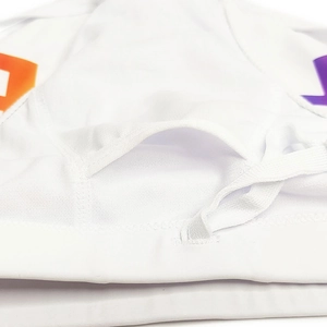 Macro detail of breathable mesh fabric and inner padding pocket on men's white swimwear