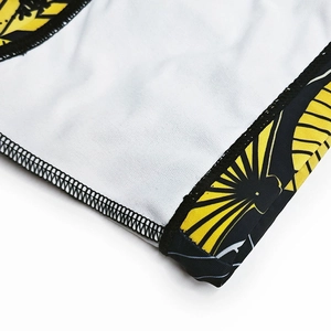 Detail shot of men's swim trunks with black-gold print and precision flatlock stitching