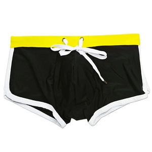 Detail of men's color-block swim trunks with adjustable white drawstring and waist piping