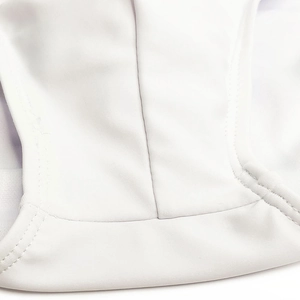 Macro detail of high-quality flatlock stitching on white men's swim trunks fabric