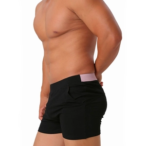 Detail view of men's slim cotton shorts with pocket and purple contrast waistband