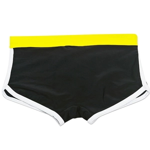 Detail view of men's athletic swim trunks featuring black fabric with yellow waist and white trim