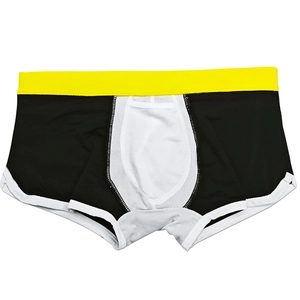 Detail of men's swim trunks with contrast yellow waistband and ergonomic U-convex pouch