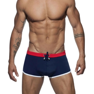 Detail of blue men's swim trunks with red waistband and drawstring with metal tips