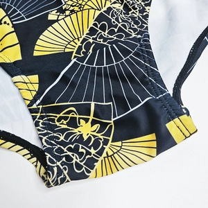 Detailed close-up of men's swim trunks featuring Japanese folding fan print and stitching