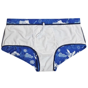 Macro detail of men's swimming trunks with traditional crane and cloud print design