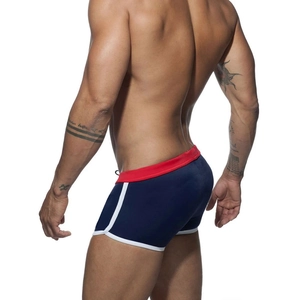 Detailed side view of men's color-block swimming trunks with red waist and white piping