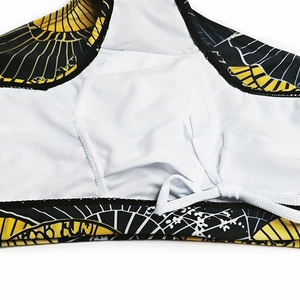 Detail of men's swim trunks featuring black and gold fan print and white drawstrings