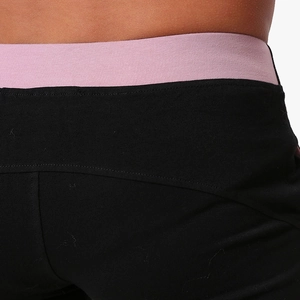 Detailed close-up of men cotton shorts waistband with contrast purple elastic and stitching