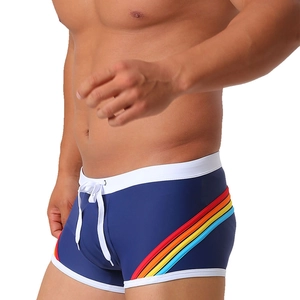 Detail of navy blue swim trunks showing waist drawstring and rainbow side stripes