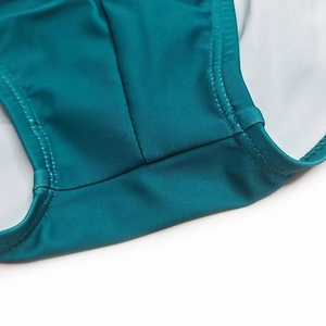Detailed close-up of teal swim briefs showing high-quality double-stitch reinforced seams