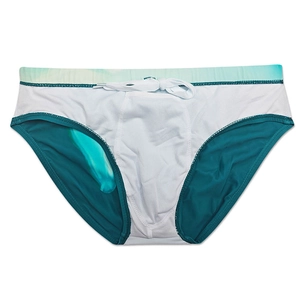 Detail view of men's white swim briefs with teal tie-dye waistband and mesh lining