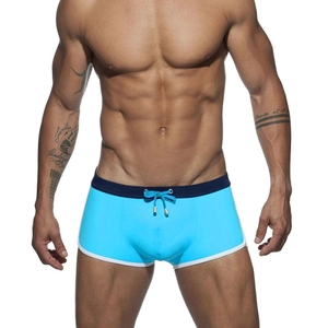 Detail of sky blue men's swim trunks with navy waist and golden drawcord tips