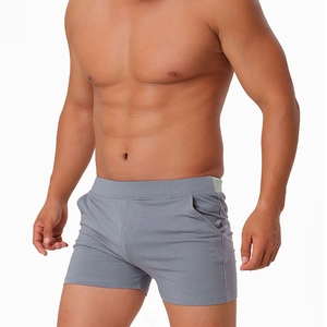 Detail view of men's cotton shorts showing functional side pockets and elastic waistband